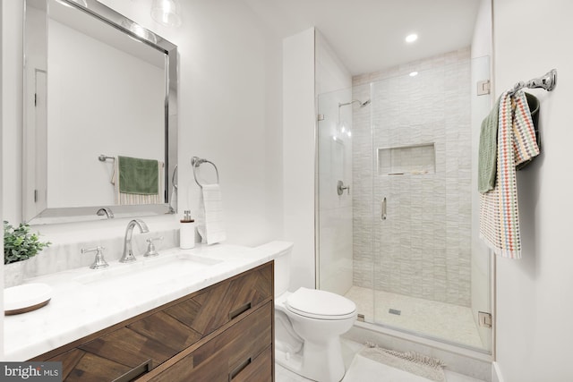 bathroom featuring an enclosed shower, vanity, and toilet