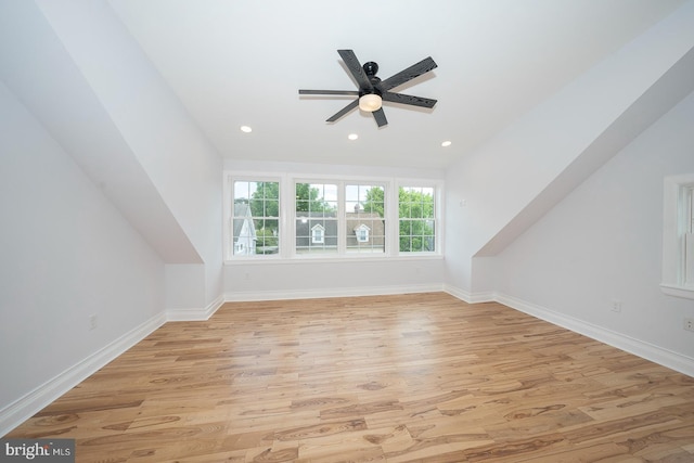 additional living space with light wood-type flooring, ceiling fan, and lofted ceiling