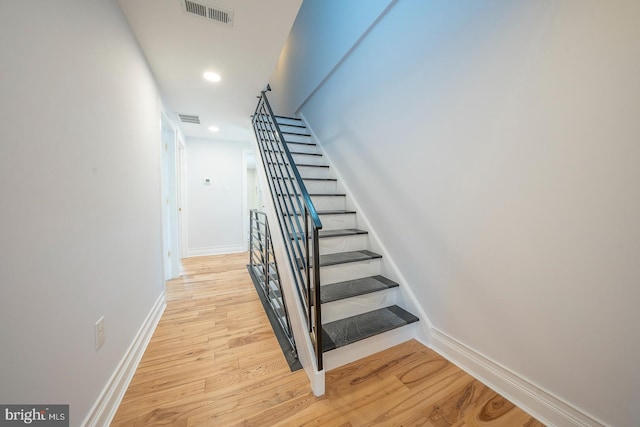 stairway with hardwood / wood-style floors