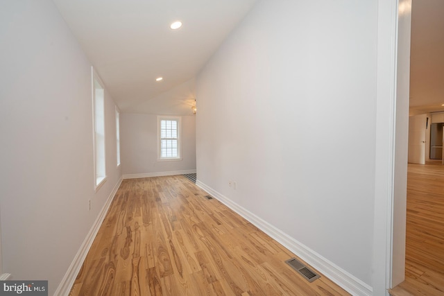 corridor with light wood-type flooring