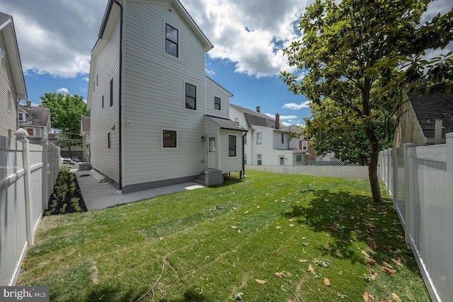 rear view of property with a lawn