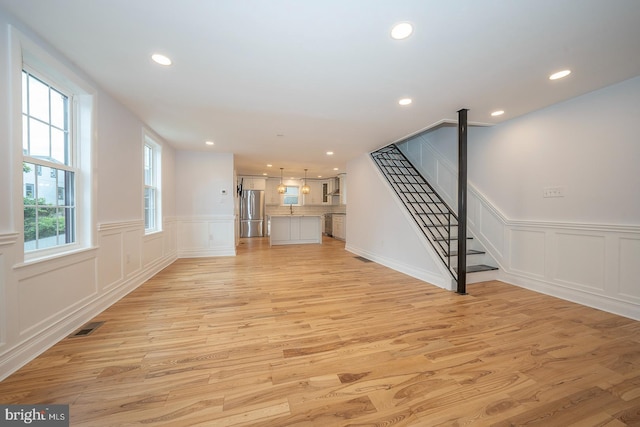 unfurnished living room featuring light hardwood / wood-style floors