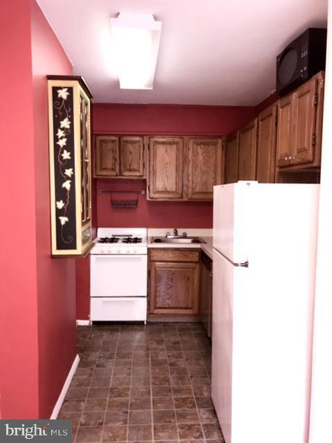 kitchen featuring sink and white appliances