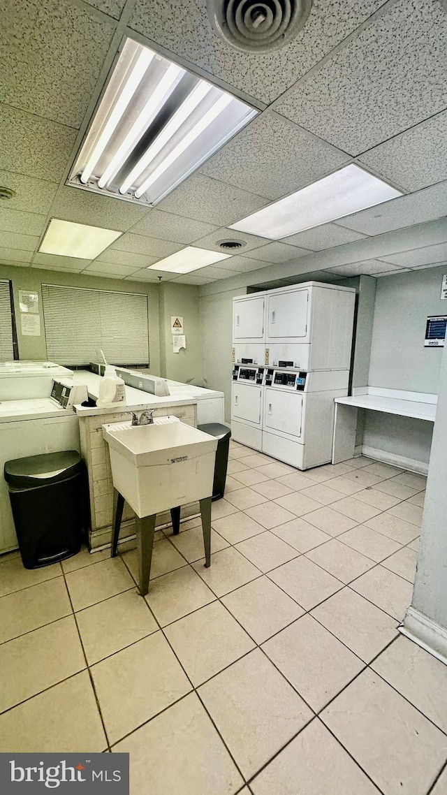 laundry room with washer and clothes dryer, light tile patterned floors, and stacked washer and clothes dryer