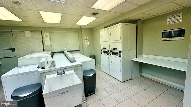 washroom with washer and clothes dryer, light tile patterned flooring, stacked washing maching and dryer, and sink