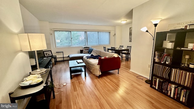 living room featuring wood-type flooring and baseboard heating