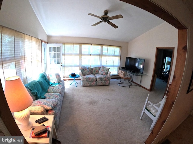 living room with ceiling fan, vaulted ceiling, and carpet flooring