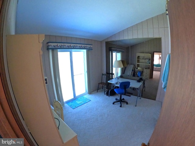 home office with carpet flooring and vaulted ceiling