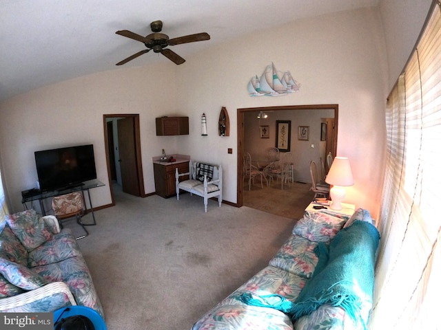 carpeted living room with ceiling fan and lofted ceiling