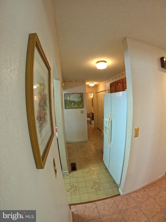 corridor featuring a textured ceiling