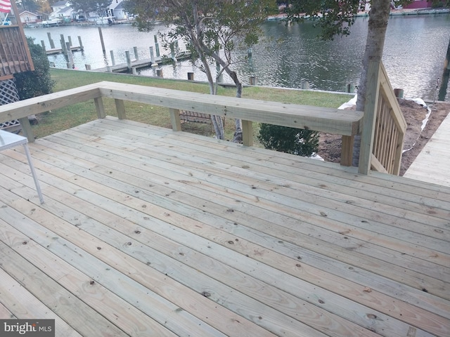 wooden terrace featuring a water view