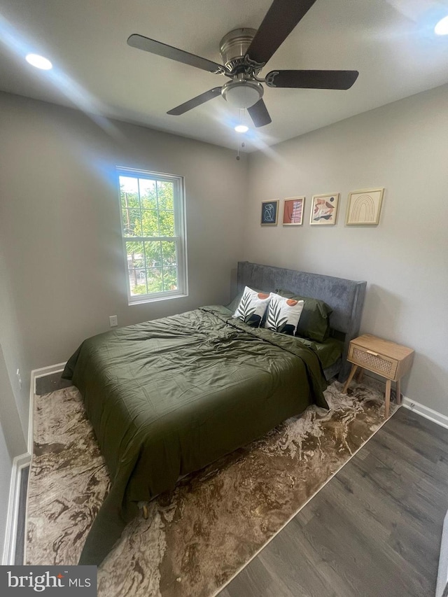 bedroom featuring dark hardwood / wood-style floors and ceiling fan