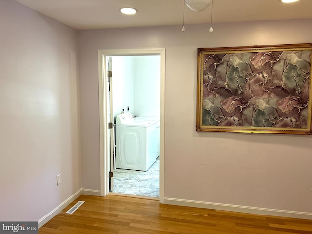 hall featuring washing machine and dryer and wood-type flooring