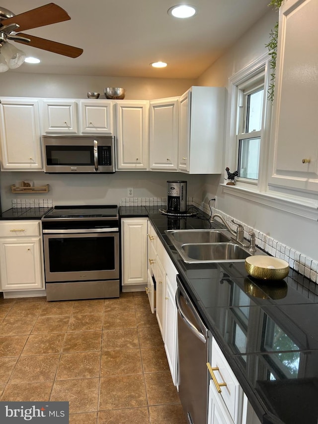 kitchen featuring white cabinetry, stainless steel appliances, and sink