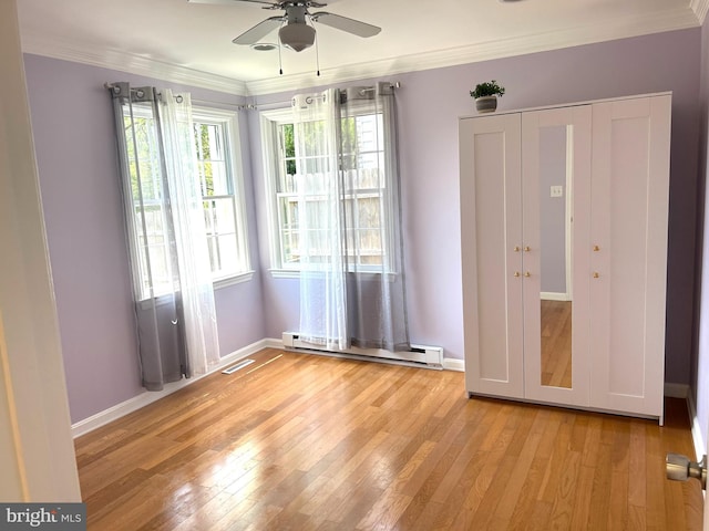 unfurnished bedroom with ceiling fan, light wood-type flooring, baseboard heating, and ornamental molding