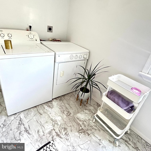 laundry room with washer and clothes dryer and light tile patterned floors