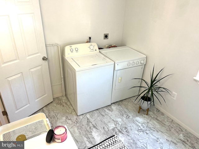 clothes washing area with light tile patterned floors and independent washer and dryer