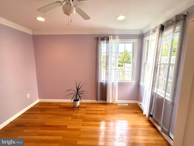 empty room featuring light hardwood / wood-style floors, crown molding, and ceiling fan