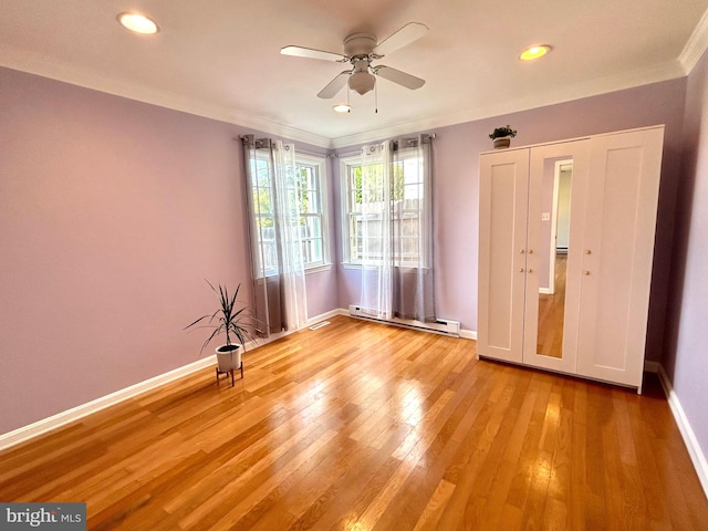 empty room featuring light hardwood / wood-style floors, a baseboard radiator, crown molding, and ceiling fan