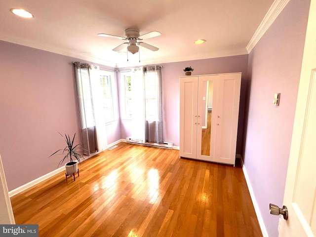 spare room with ornamental molding, light wood-type flooring, and ceiling fan