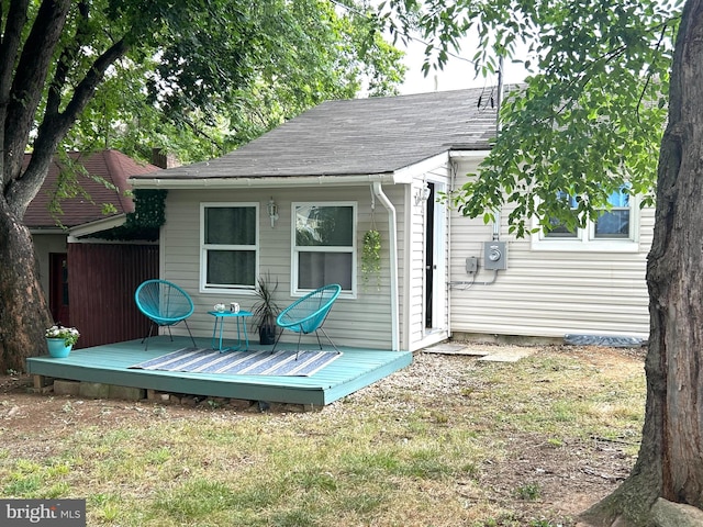 back of house featuring a wooden deck