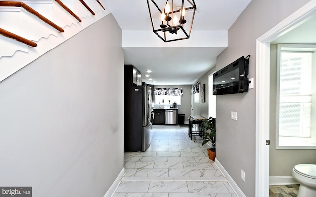 hallway featuring a notable chandelier