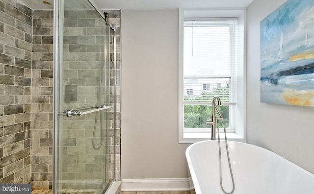 bathroom featuring shower with separate bathtub