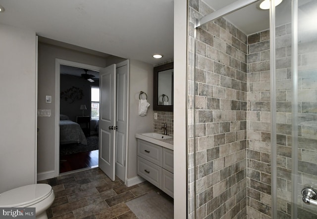 bathroom with ceiling fan, backsplash, an enclosed shower, toilet, and vanity