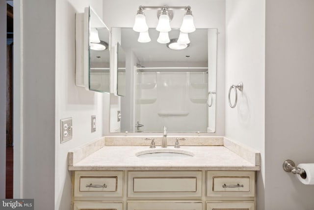 bathroom featuring a shower and vanity