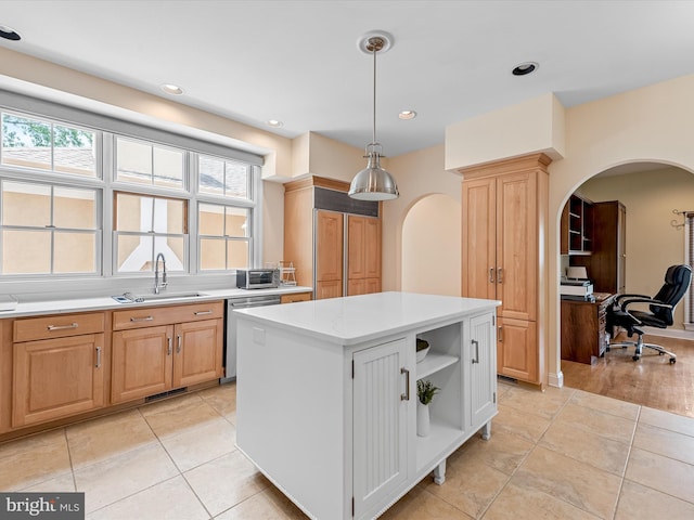 kitchen with light brown cabinetry, sink, dishwasher, a center island, and hanging light fixtures