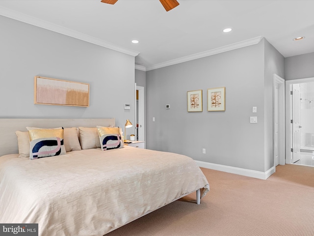 bedroom with ensuite bathroom, ceiling fan, light colored carpet, and ornamental molding