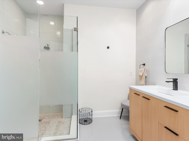 bathroom featuring a tile shower, tile patterned floors, backsplash, vanity, and tile walls