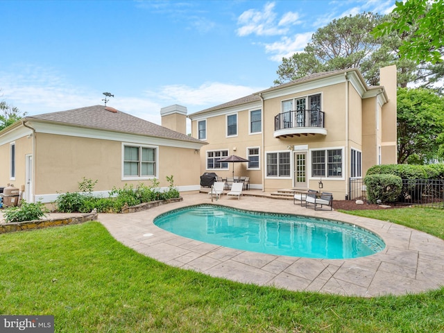 exterior space with a yard, a patio area, and a balcony