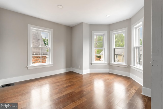 empty room with dark wood-type flooring