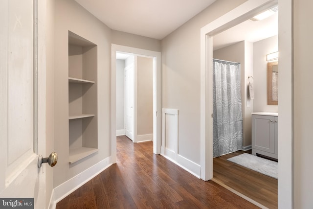 bathroom featuring hardwood / wood-style floors, vanity, and built in features