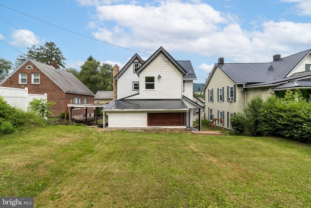 rear view of house with a lawn