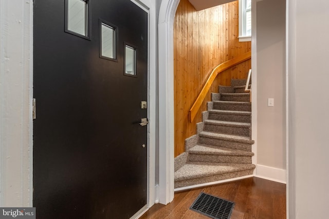 foyer featuring wood walls and hardwood / wood-style floors