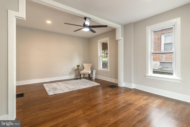 unfurnished room featuring ceiling fan and dark hardwood / wood-style flooring