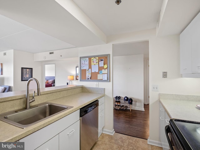 kitchen with sink, white cabinets, stainless steel appliances, and light hardwood / wood-style flooring