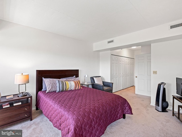 carpeted bedroom with a closet