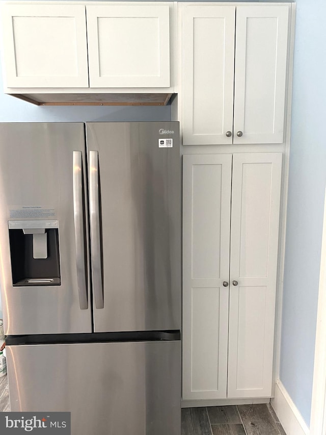 kitchen featuring white cabinetry and stainless steel fridge