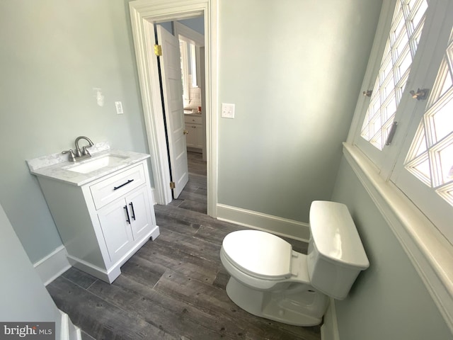 bathroom featuring hardwood / wood-style flooring, vanity, and toilet