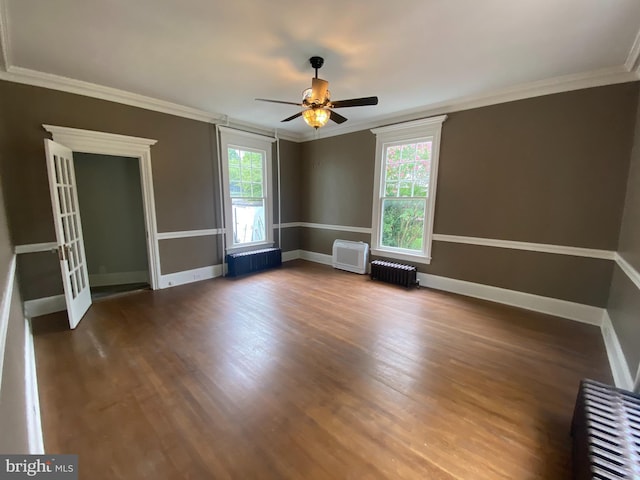 unfurnished room featuring crown molding, a healthy amount of sunlight, and radiator