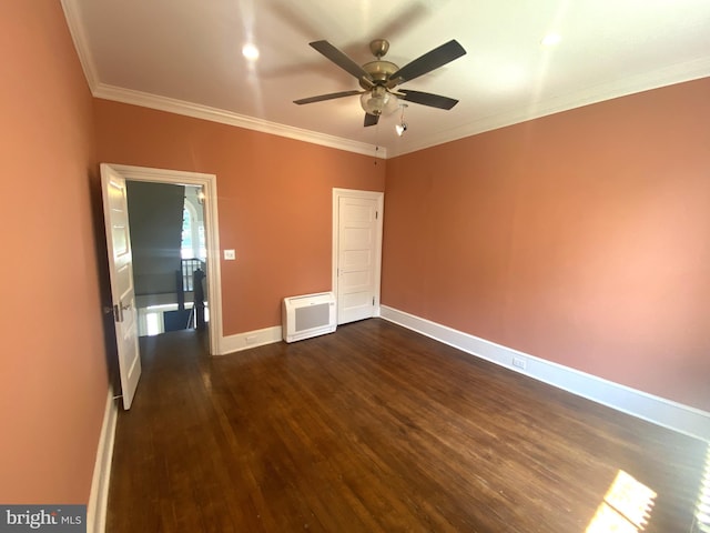 unfurnished bedroom with crown molding, dark wood-type flooring, heating unit, and ceiling fan