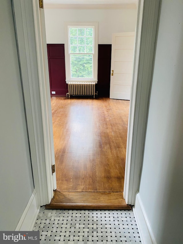 corridor with radiator and ornamental molding