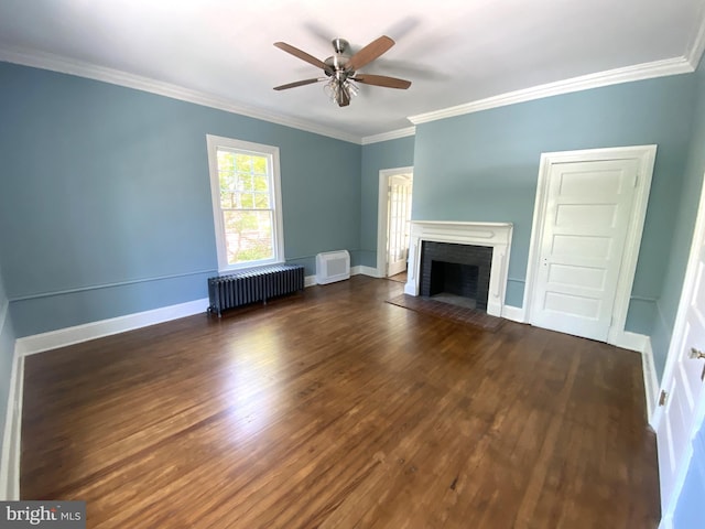 unfurnished living room featuring ornamental molding, radiator, ceiling fan, and a fireplace