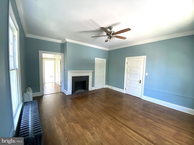 unfurnished living room with crown molding, ceiling fan, dark hardwood / wood-style floors, and a brick fireplace