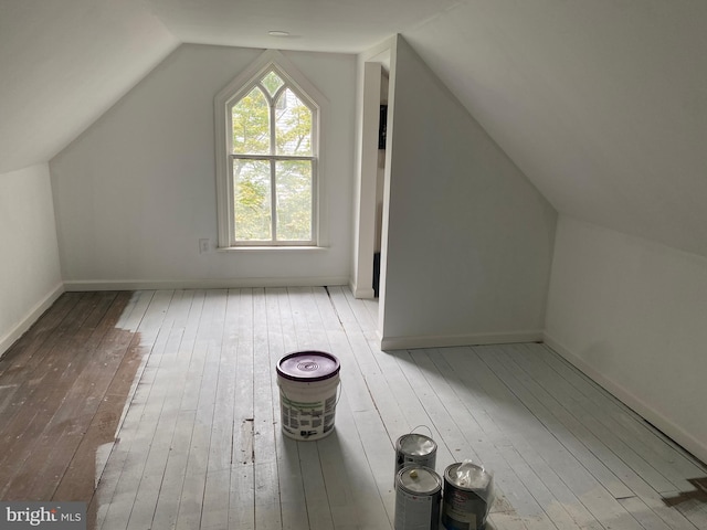 bonus room with vaulted ceiling and light hardwood / wood-style floors