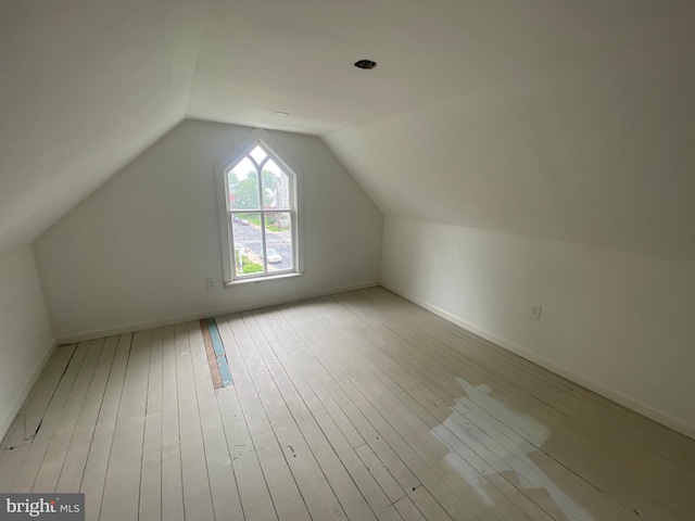 bonus room with lofted ceiling and light hardwood / wood-style flooring