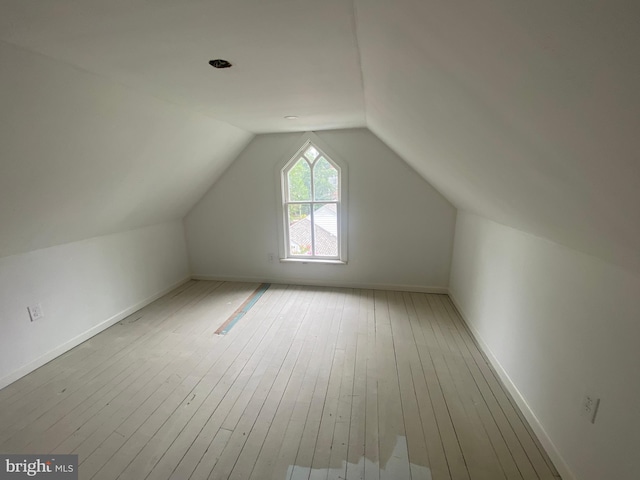 bonus room featuring lofted ceiling and light hardwood / wood-style flooring